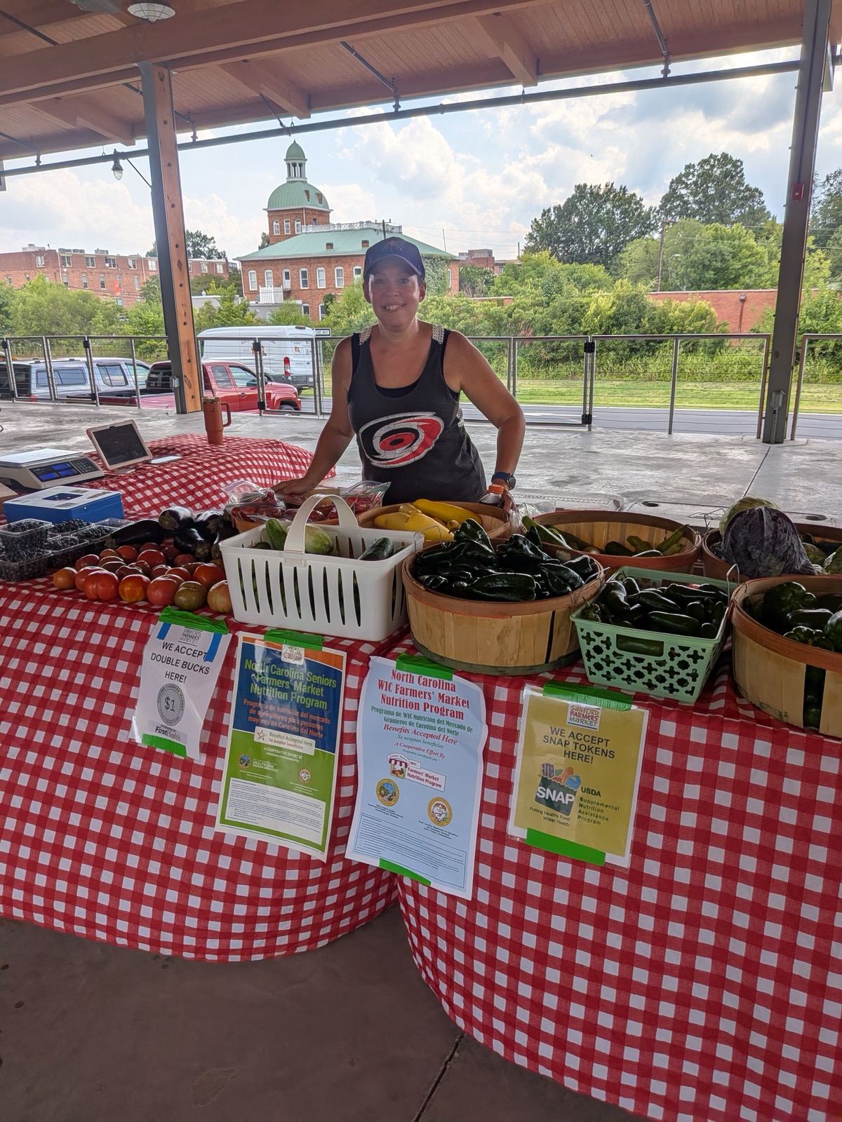 The Pine Haven vendor with a colorful display of seasonal produce